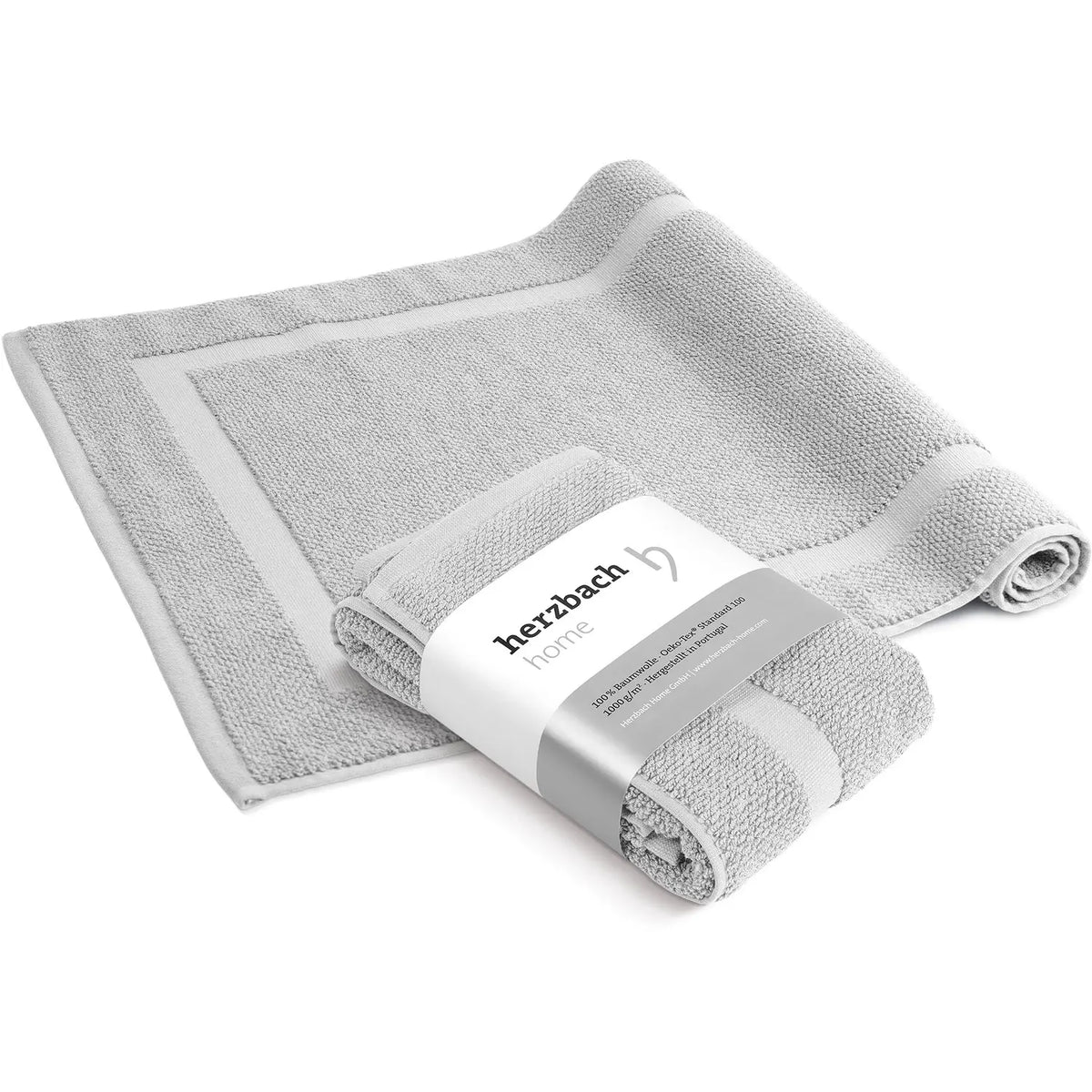 Spa Badvorleger Creme 2er Set – Nahaufnahme der Seite, aufgerollter Badvorleger mit grob strukturiertem Bouclé-Frottier und hellem Rahmenabschluss, warmer Cremeton, 100% Baumwolle