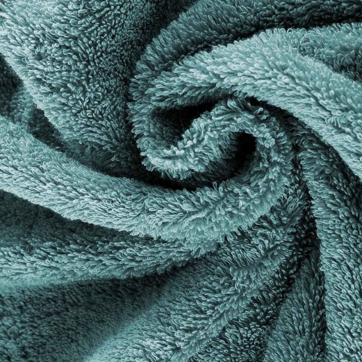Pura Ozeangrün – Nahaufnahme der dichten Frottier-Schlaufen in wellenförmiger Spirale, besonders weiche und voluminöse Textur