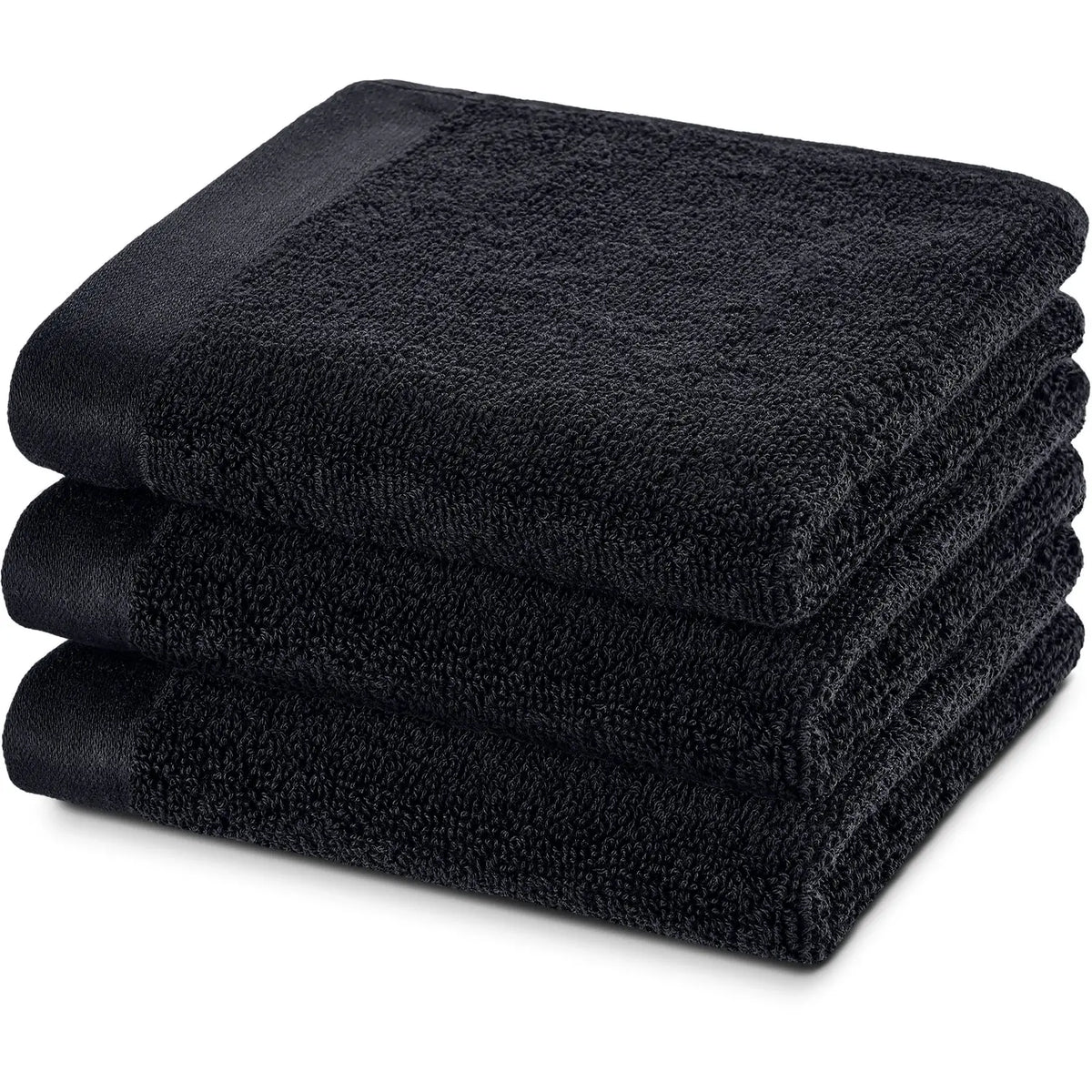 Gästehandtuch Deep Black 3er Set – drei übereinander gestapelte gefaltete Gästehandtücher von schräg vorne, tiefschwarzes Frottier mit satiniertem Saum und herzbach home Logostickerei, 30 x 50 cm
