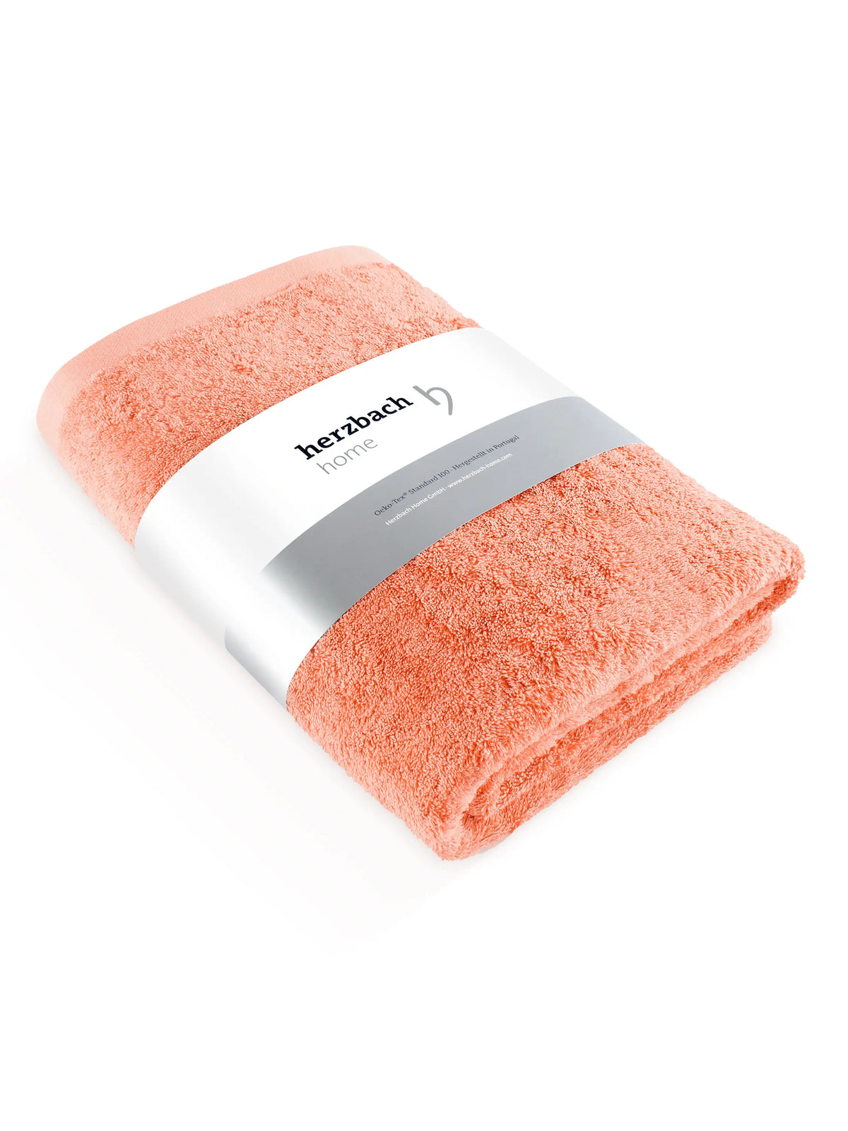 Gefaltetes Pura Saunatuch in Coral mit herzbach home Papierbanderole