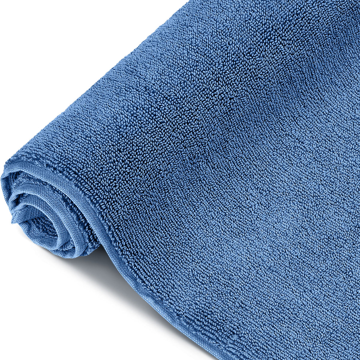 Pura Badvorleger Blau – aufgerollte Seitenansicht in Nahaufnahme, voluminöse und flauschige Frottier-Qualität in sattem Blauton, 1200 g/m²