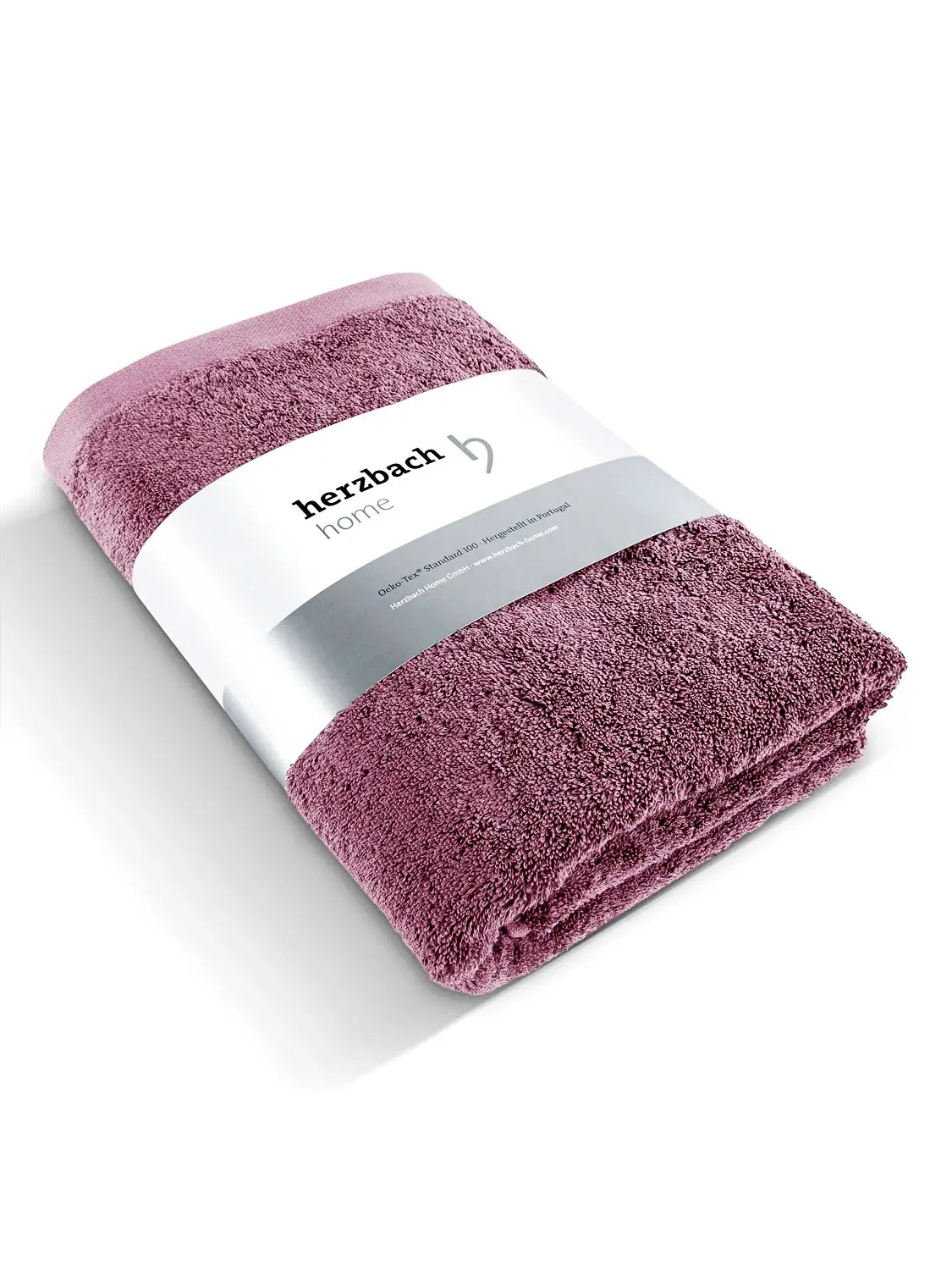 Gefaltetes Pura Saunatuch in Malve mit herzbach home Papierbanderole
