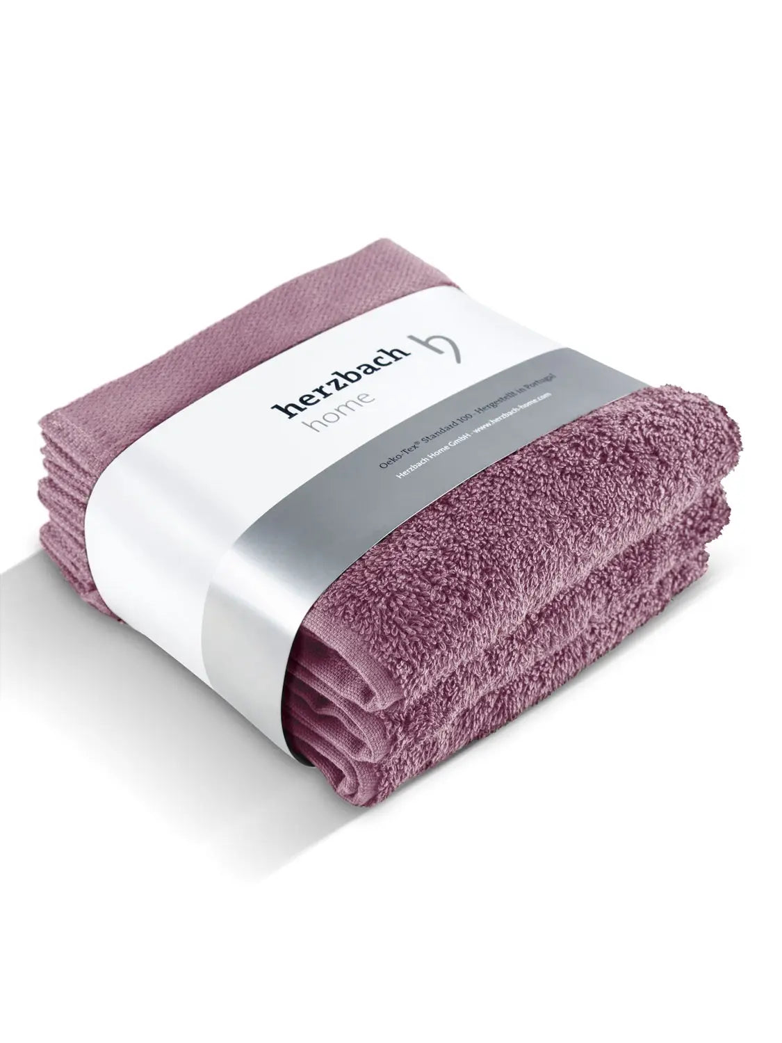 Drei gefaltete malvefarbene Pura Seiftücher mit Herzbach Home Papierbanderole
